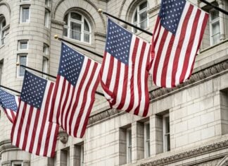 Flags flying in front of a U.S. building