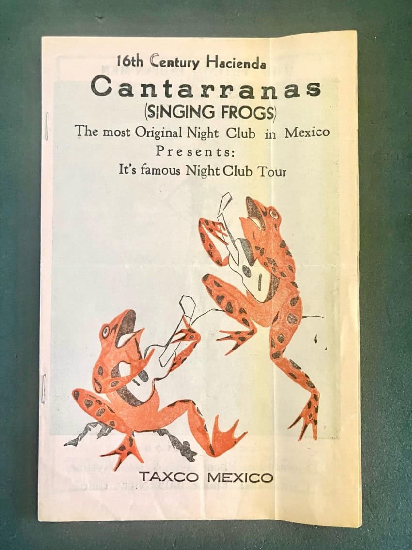Two orange frogs singing and playing guitar on a 16th century poster