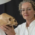 Professor Vera Tiesler holding an ancient skull