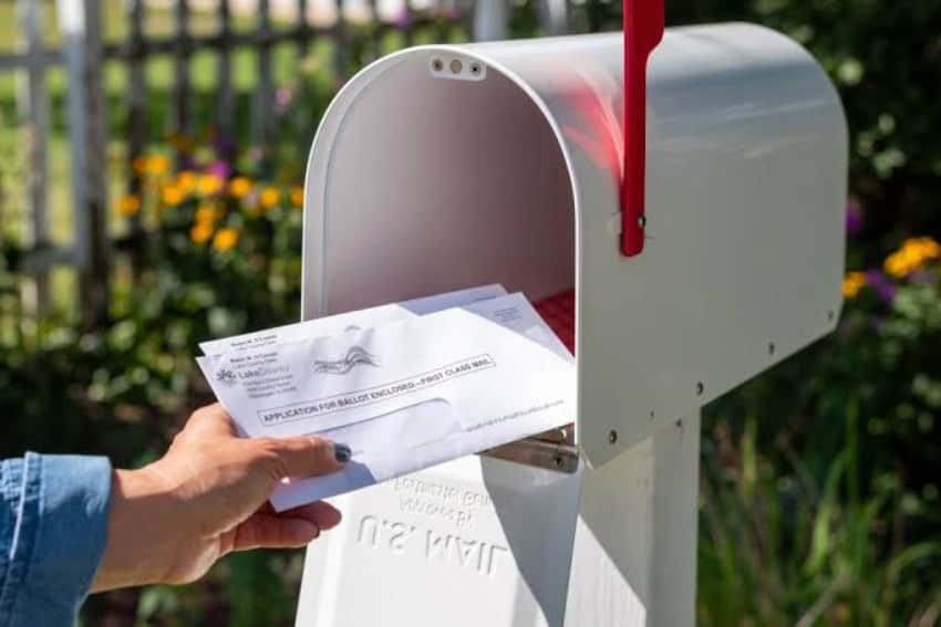 Mail being put in a mailbox