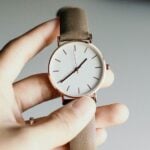 Hand holding a watch
