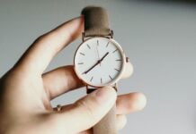 Hand holding a watch