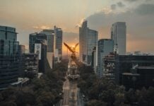 An aerial view of the Angel de la Independencia in Mexico City at sunset.