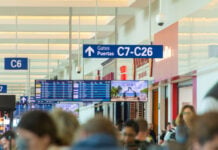 Cancun, Quintana Roo, Mexico - December 6, 2022: A large crowd of people fill up the halls of the Cancun International Airport in Mexico.