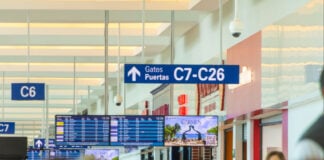 Cancun, Quintana Roo, Mexico - December 6, 2022: A large crowd of people fill up the halls of the Cancun International Airport in Mexico.