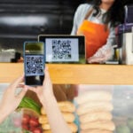 A client makes a QR code payment at a market