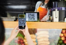 A client makes a QR code payment at a market