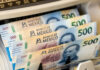 A bill counting machine counting 500-Mexican peso bills