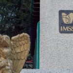 Xalapa, Mexico - February 24, 2026 - Photograph of the entrance to IMSS Health Clinic No. 10 in the city of Xalapa, featuring a golden angel statue next to the sign.