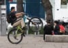 A young man on a bicycle pops a wheelie as he rides down Paseo de La Reforma in Mexico City.