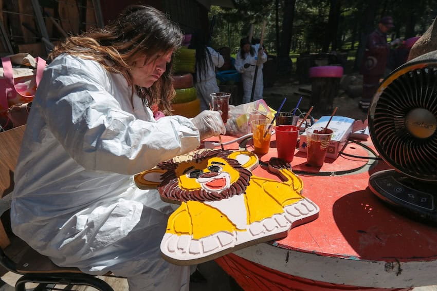 City worker turning discarded materialinto park amenities