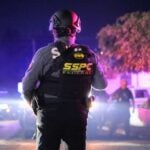 police officer looking out at a crime scene in Morelos