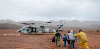 Soldiers and guardsmen on Monday rescued 32 people stranded outside Ensenada, Baja California, after a mudslide caused by Tropical Storm Rachel cut off their only escape route.