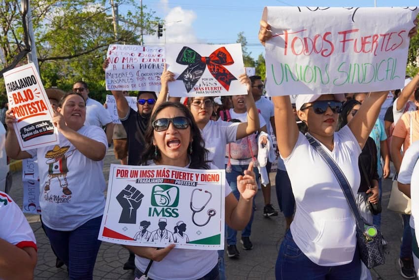 IMSS workers took to the streets in Cancún on Tuesday with signs demanding better working conditions.