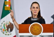 President Sheinbaum gestures behind the podium of her Wednesday October 21 press conference.