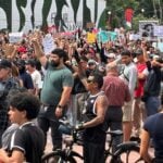 Protesters raise fists in solidarity at Guadalajara water protest.