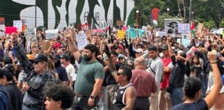 Protesters raise fists in solidarity at Guadalajara water protest.