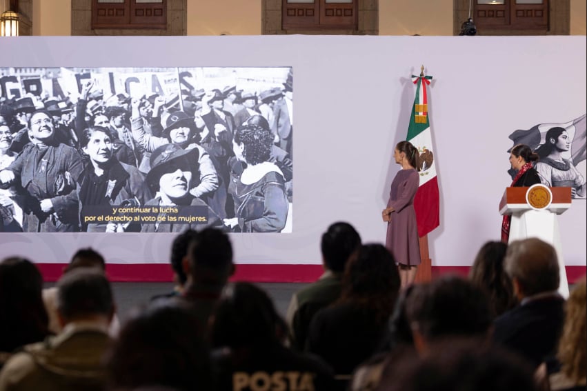 President Sheinbaum looks at a slide showing women protesting for the right to vote, during her Oct. 1, 2026, press conference