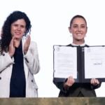 Sheinbaum signing a decree alongside her legal counsel Luisa Alcalde
