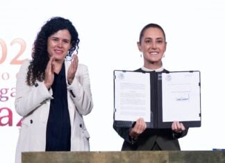 Sheinbaum signing a decree alongside her legal counsel Luisa Alcalde