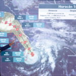 National Meteorological Service chief Fabián Vázquez gestures at a projection of the path of Hurricane Trudy along Mexico's Pacific coast