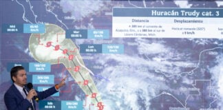 National Meteorological Service chief Fabián Vázquez gestures at a projection of the path of Hurricane Trudy along Mexico's Pacific coast
