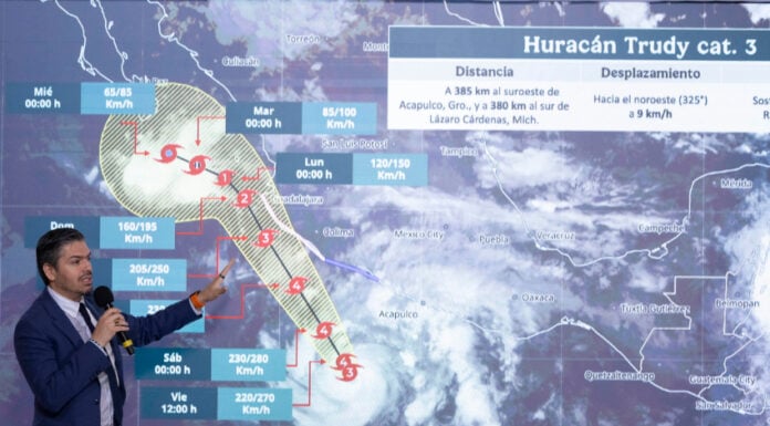 National Meteorological Service chief Fabián Vázquez gestures at a projection of the path of Hurricane Trudy along Mexico's Pacific coast