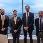 García alongside executives of Apollo Global Management