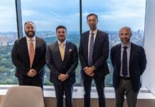 García alongside executives of Apollo Global Management