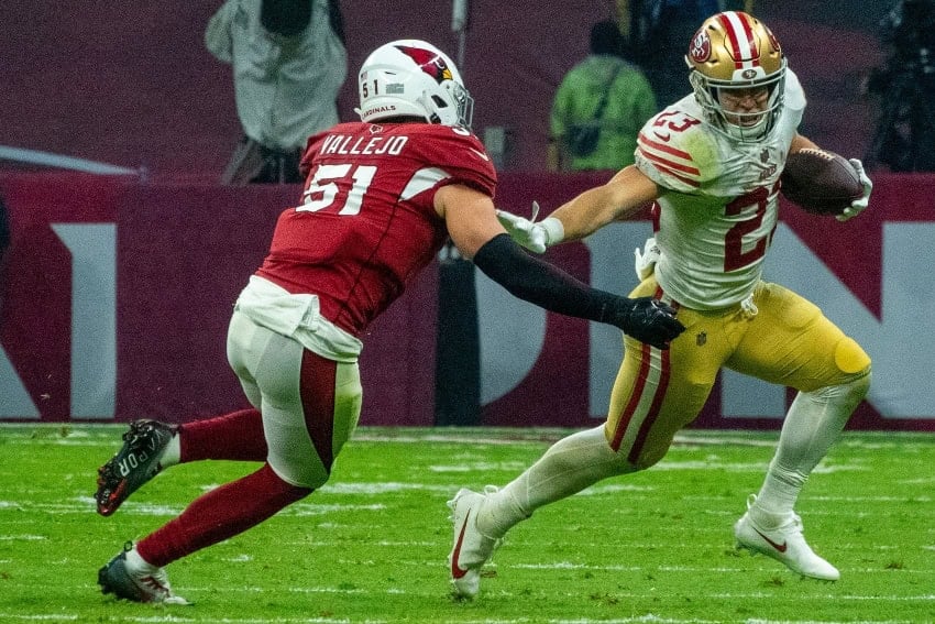 San Francisco 49ers running back Christian McCaffery carries the ball against the Arizona Cardinals during a 2022 game at Estadio Azteca in Mexico City