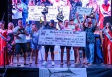 Winning team at Bisbee's Black and Blue 2026 fishing tournament in Los Cabos holding up trophies and check.