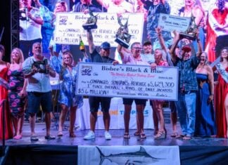 Winning team at Bisbee's Black and Blue 2026 fishing tournament in Los Cabos holding up trophies and check.