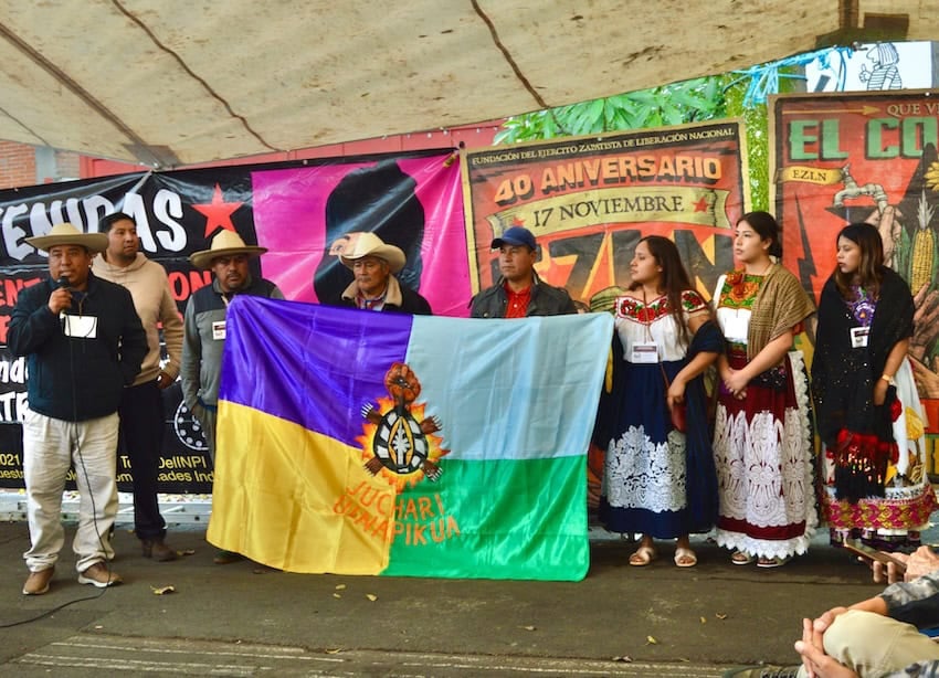 Delegates from the Purépecha community of Santa Fe de la Laguna, Michoacán, display their flag.