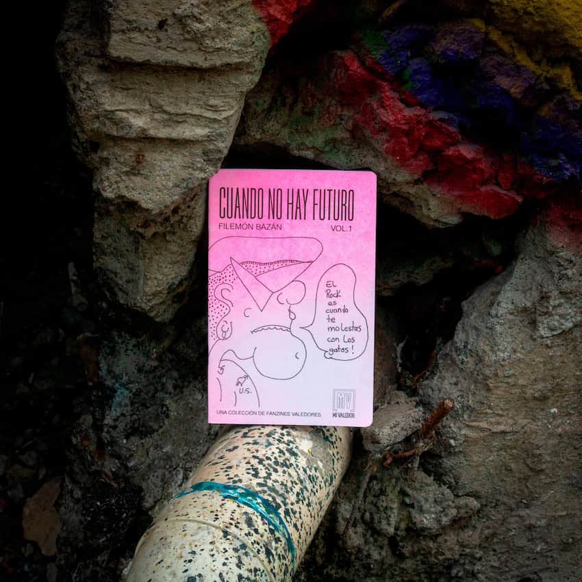 A pink magazine presented in an artful way on a drainpipe.