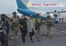 Mexican authorities escort accused fuel smuggler and former Navy officer Miguel Ángel Solano Ruiz, aka "Capitán Sol," onto a plane in handcuffs