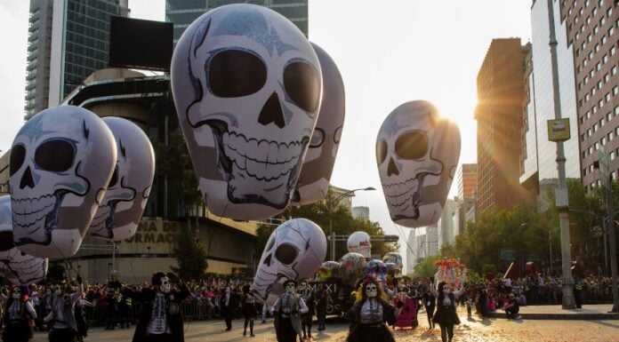 Day of the Dead parade in Mexico City with elaborate skulls.