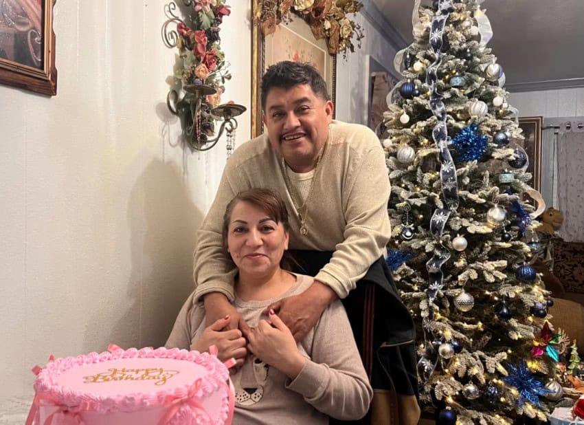 Photo of Emiliano Andrade-Covarrubias and his wife, María, with a cake and a Christmas tree