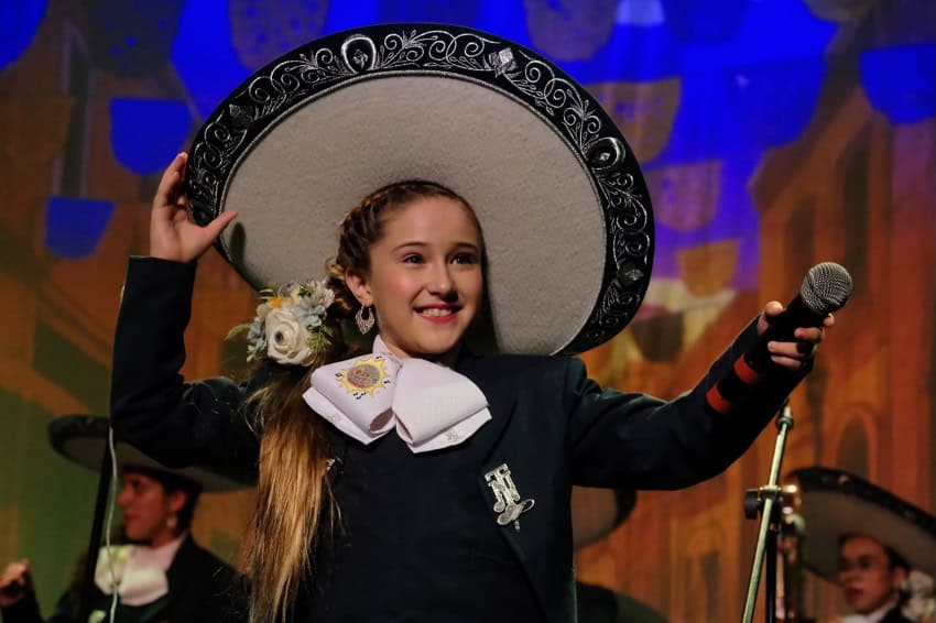 Young female mariachi in costume