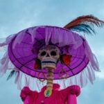 Low angle of a Catrina skeleton set against the sky.