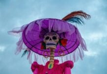 Low angle of a Catrina skeleton set against the sky.