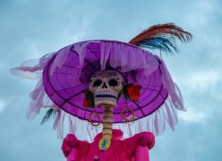 Low angle of a Catrina skeleton set against the sky.