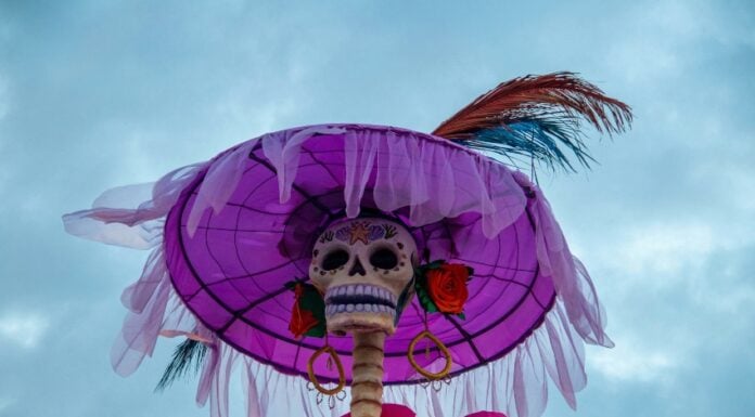 Low angle of a Catrina skeleton set against the sky.