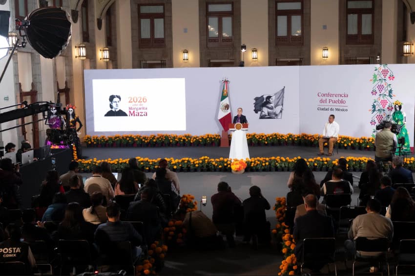 The president at the podium her Friday conference in the Treasury Hall of the National Palace, which was decked in marigolds and catrina figures in honor of Day of the Dead.