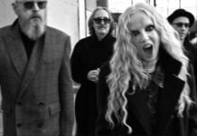 Alt-rock band Garbage - lead singer Shirley Manson screams at the camera, with bandmates in jackets behind her