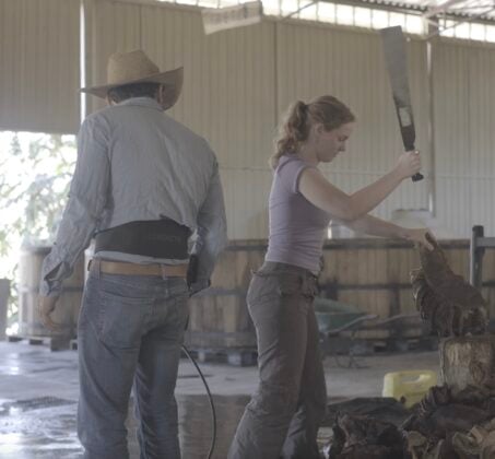 The author of this article chopping the agave plant inside the company's factory. (Abigail-Rose Maley)