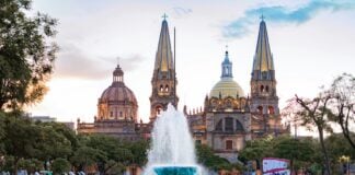 People gather near a water fountain at Plaza de la Liberación in Guadalajara, Mexico.