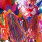 A close-up shot of multiple Mexican piñatas.
