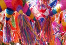 A close-up shot of multiple Mexican piñatas.