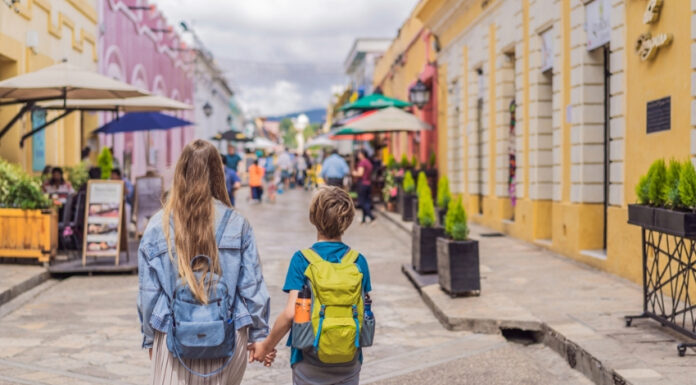 A blond woman and child walk down a colonial Mexican street in San Cristobal de las Casas, Chiapas