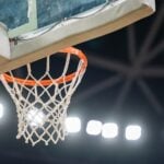 Basketball hoop hanging in a sports stadium waiting for the ball